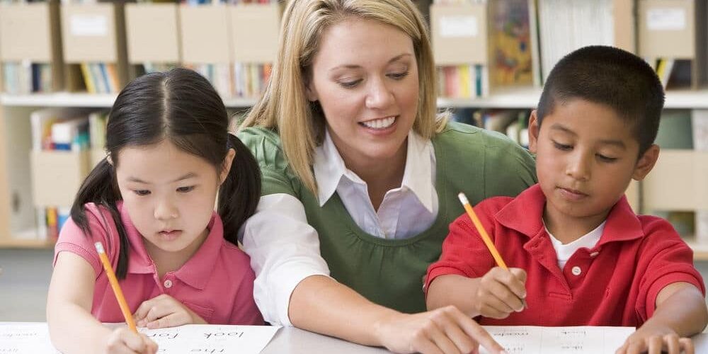 Women-Tutoring-two-Kids kids getting tutored