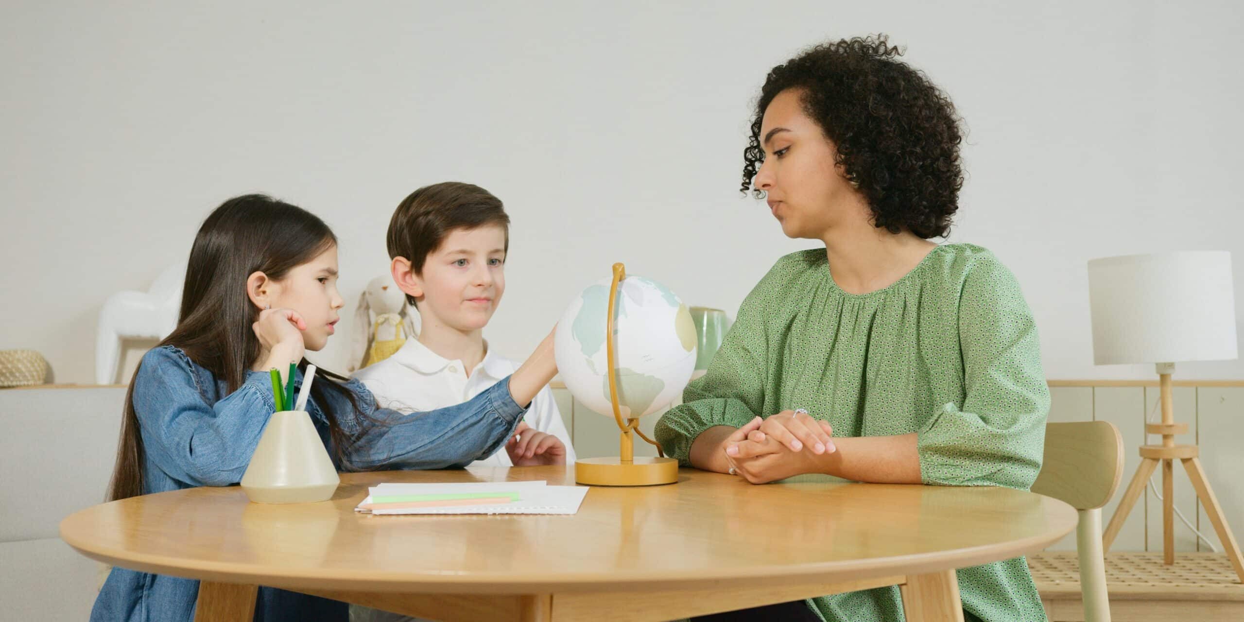 woman and kids sitting at a table woman-and-kids-sitting-at-a-table
