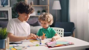 mother and son playing at table