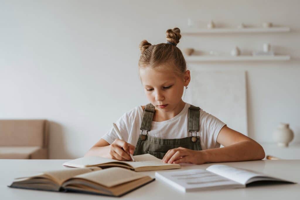 Young girl reading and writing