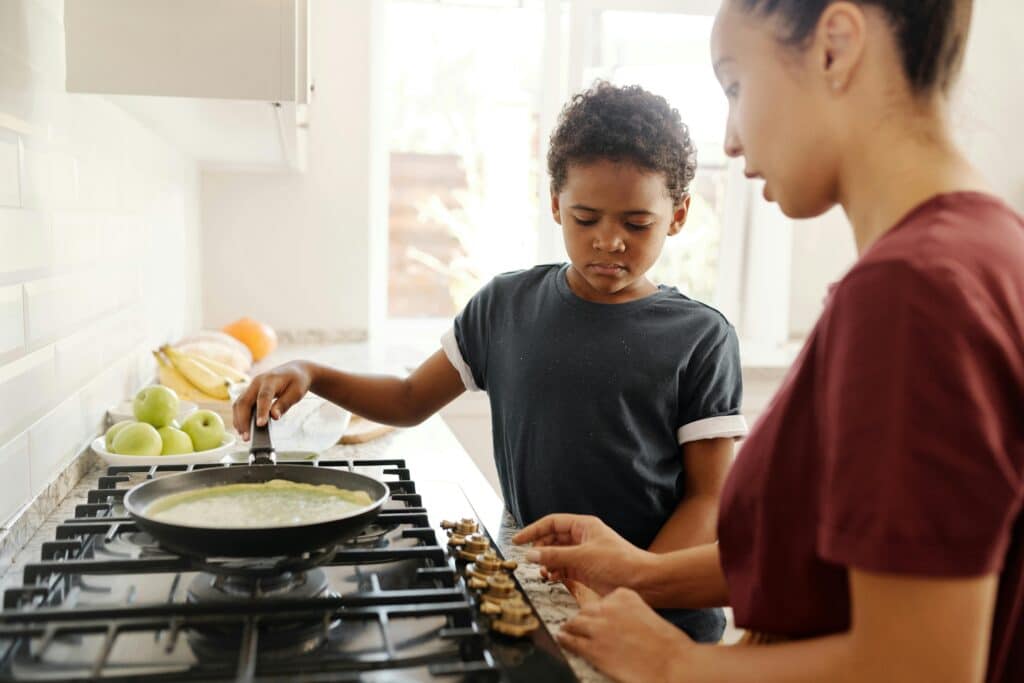 young kid learning to cook