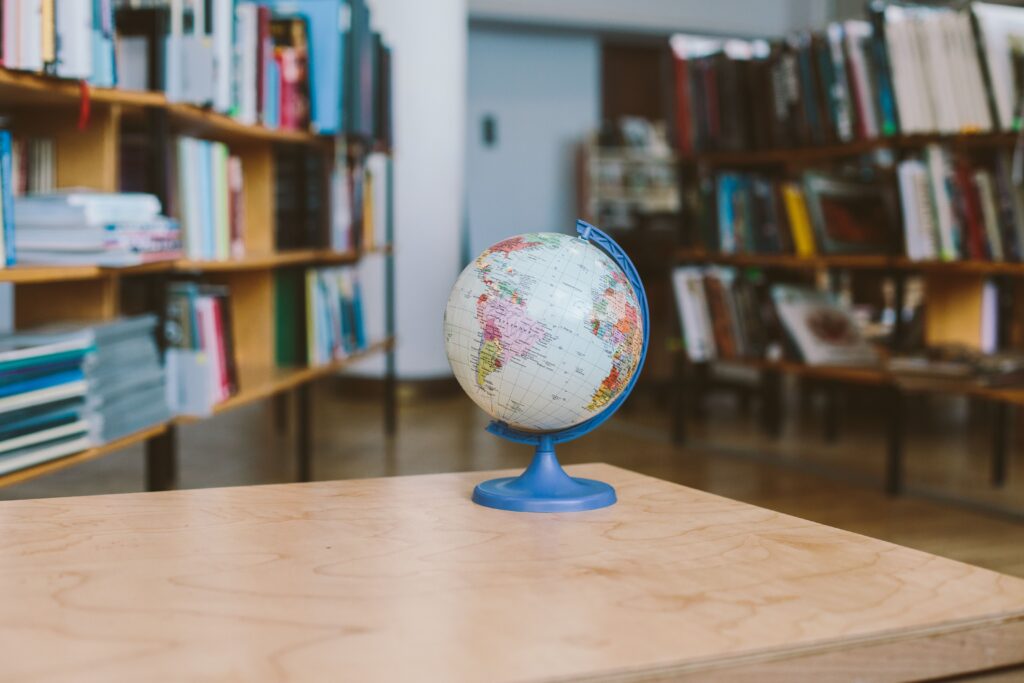 A globe surrounded by shelves filled with books