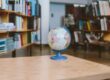 A globe surrounded by shelves filled with books