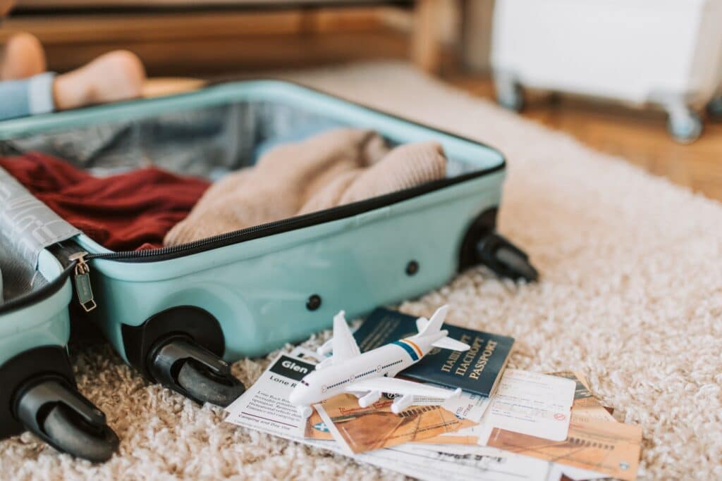 Close-up of an open suitcase with travel essentials